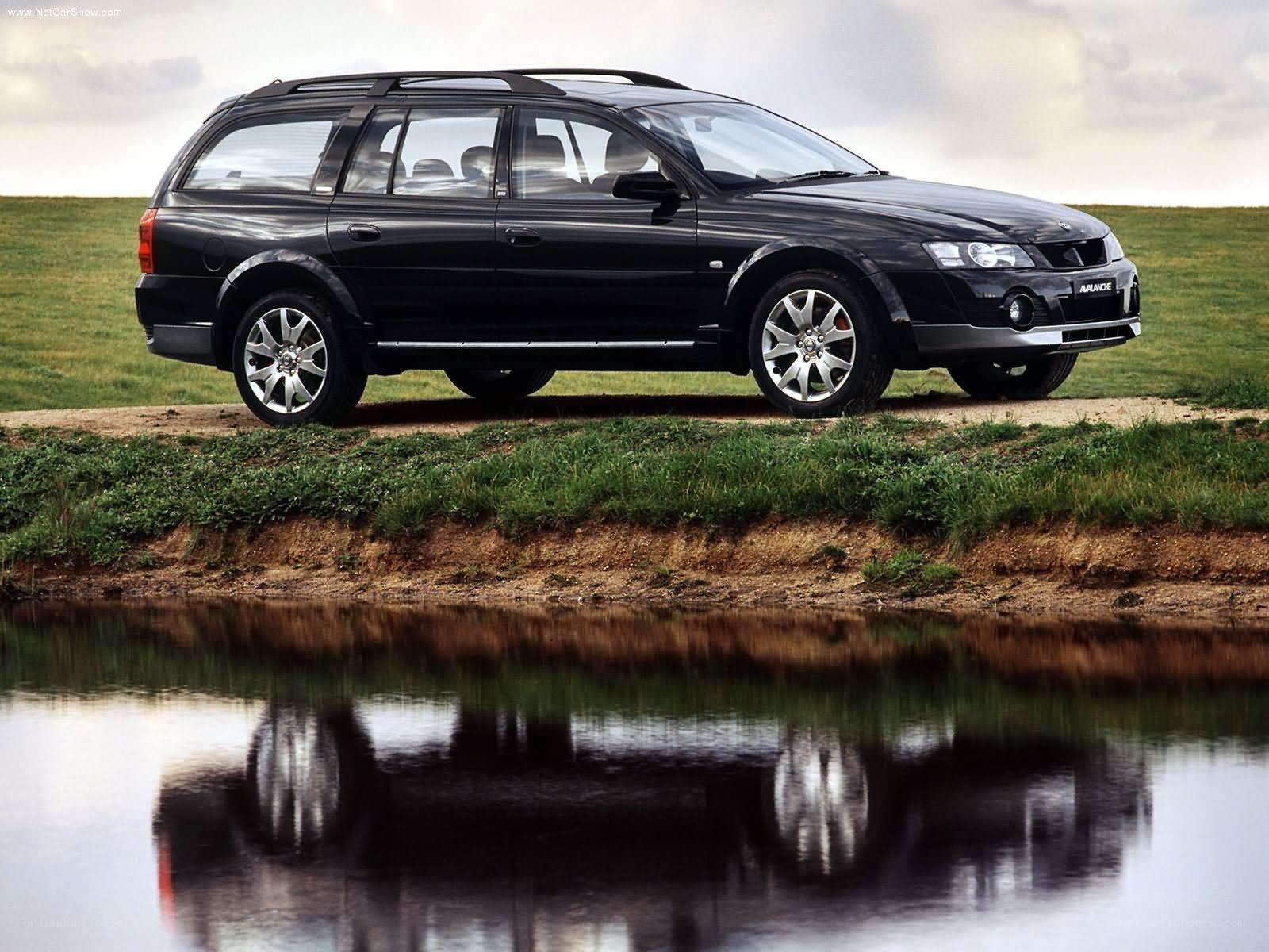 black station wagon by water