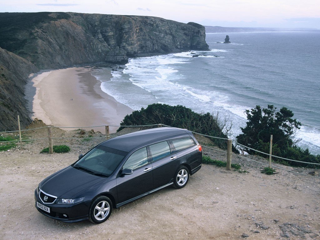 Black station wagon on cliffside