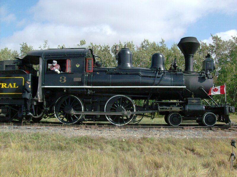 Black Steam Locomotive — Calm, Afternoon, Photograph, Canadian Flag