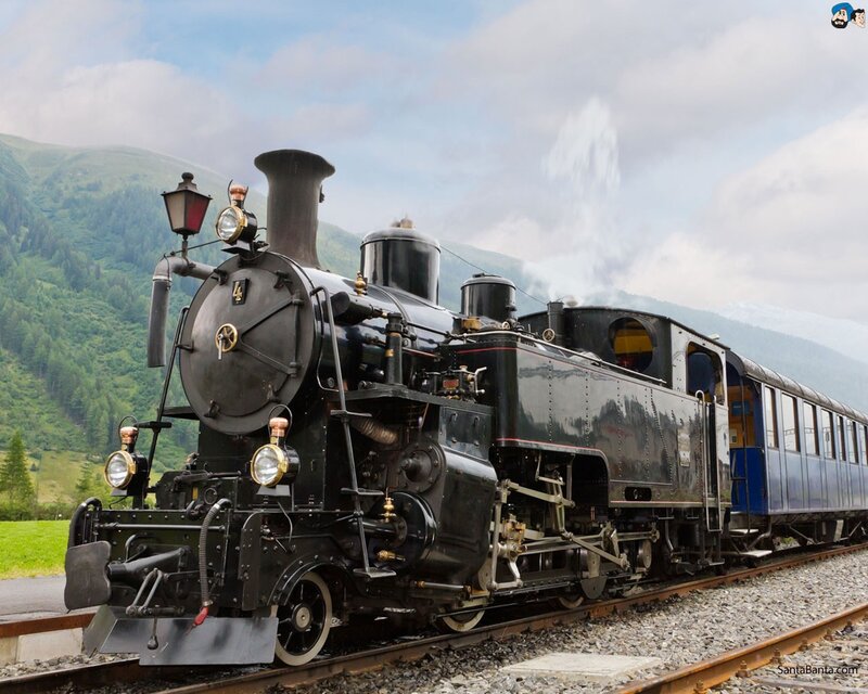 Black steam locomotive on mountain track