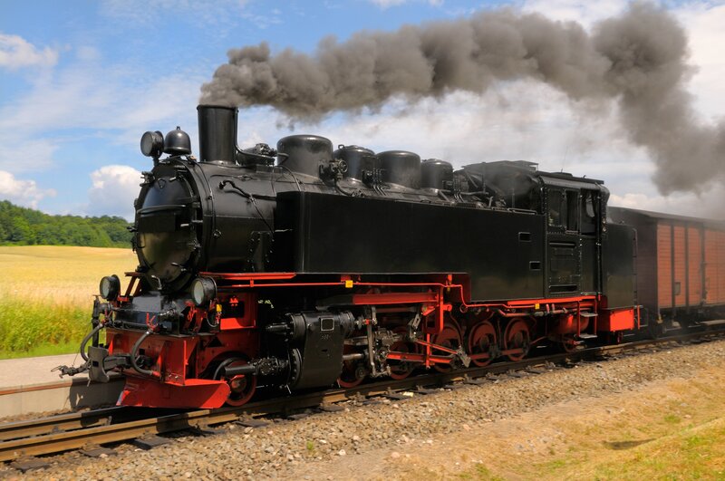 Black steam locomotive on tracks