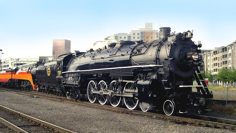 Black steam locomotive on tracks