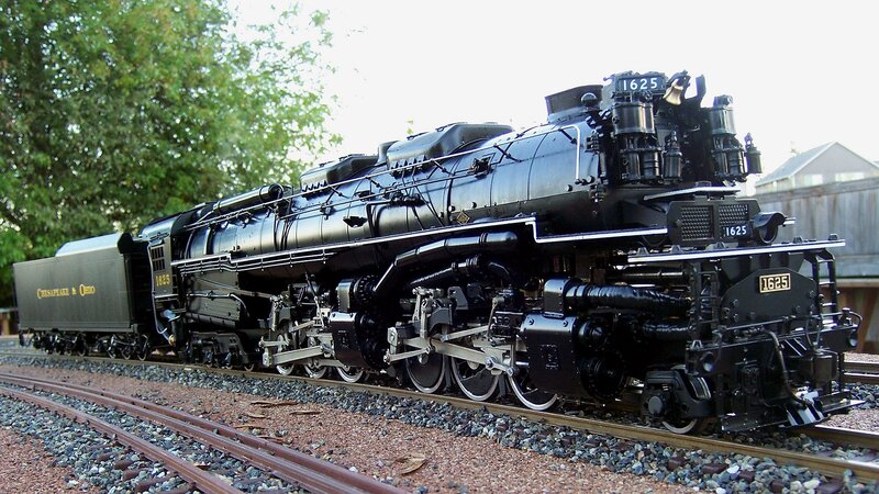 Black steam locomotive on tracks