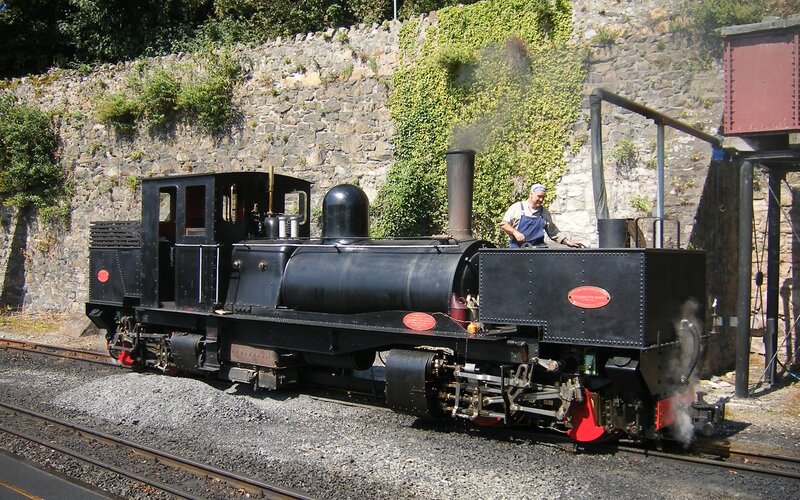 Black steam locomotive on tracks