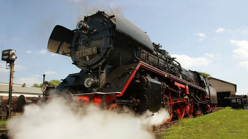 Black steam locomotive on tracks