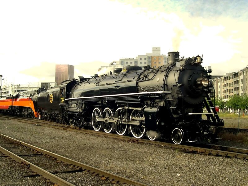 Black steam locomotive on tracks