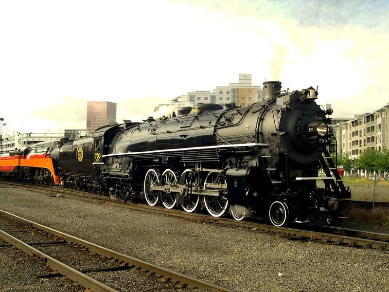 Black steam locomotive on tracks