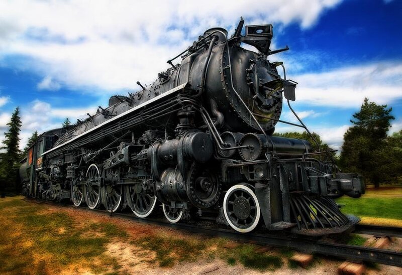 black steam locomotive on tracks