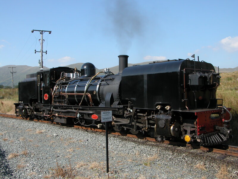 Black steam locomotive on tracks