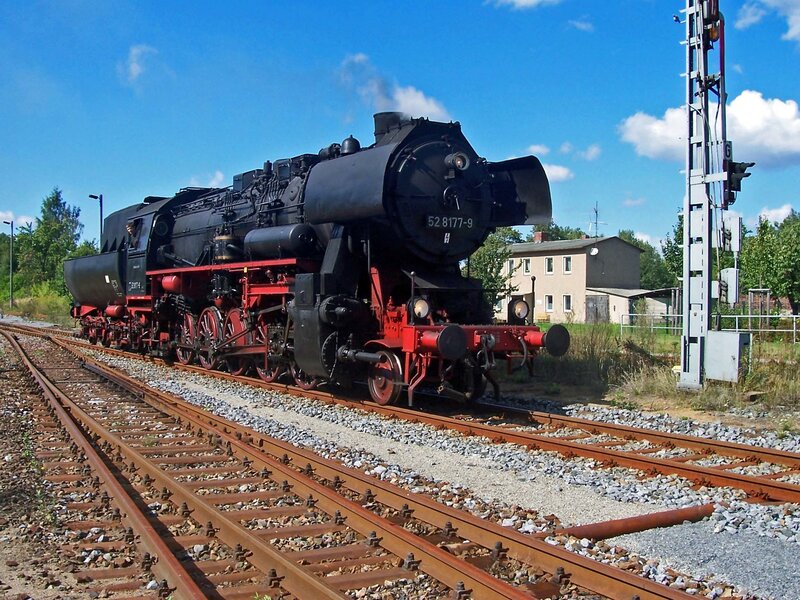 Black steam locomotive on tracks