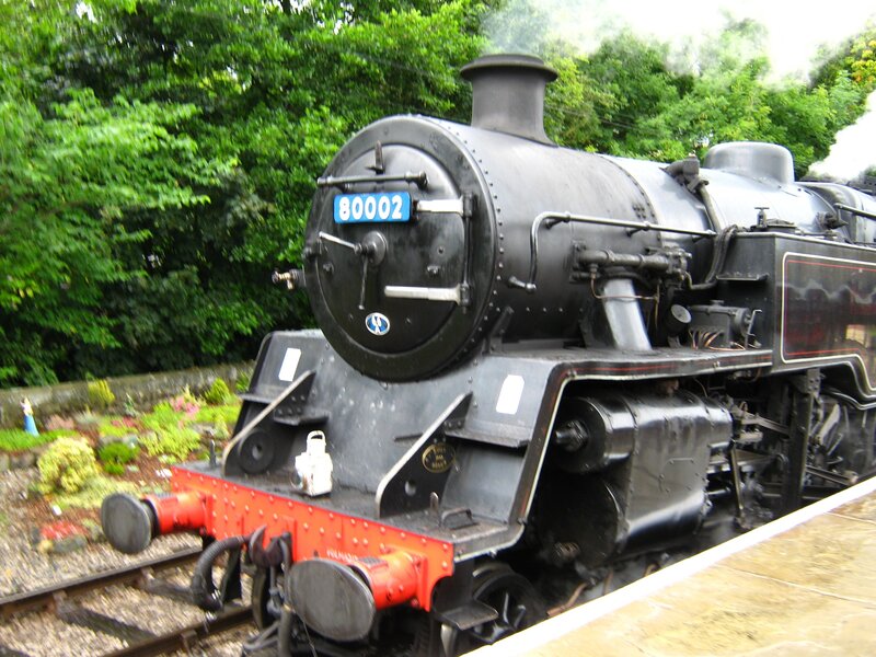 Black steam locomotive on tracks