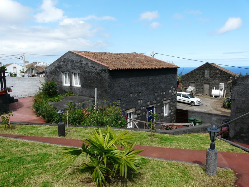 Black stone house with red roof