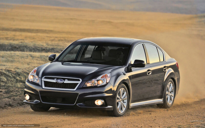 Black Subaru driving on dirt road