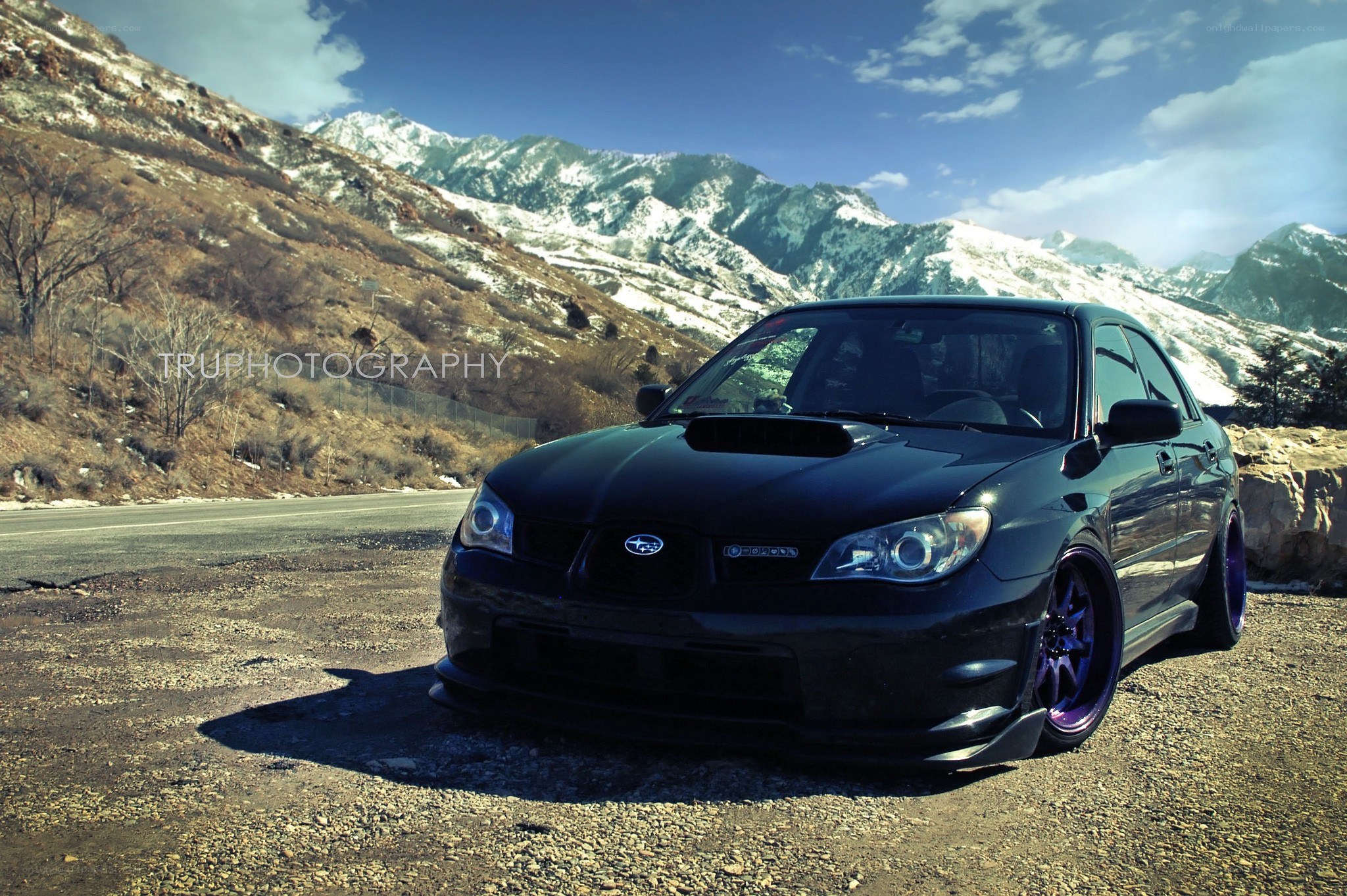 Black Subaru in mountain landscape