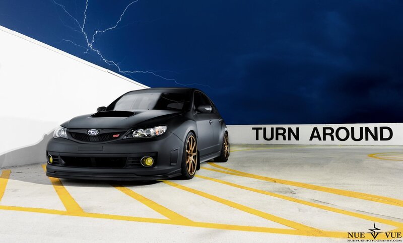 Black Subaru in parking garage