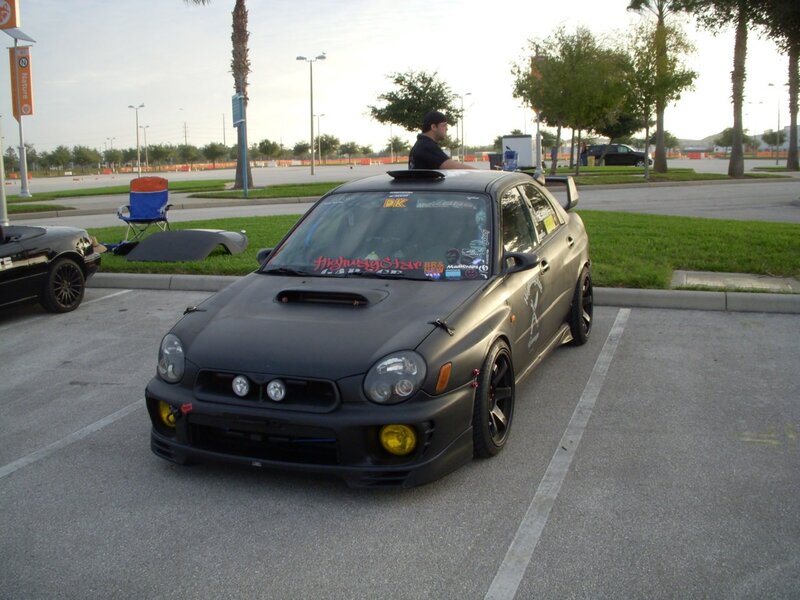 black subaru in parking lot