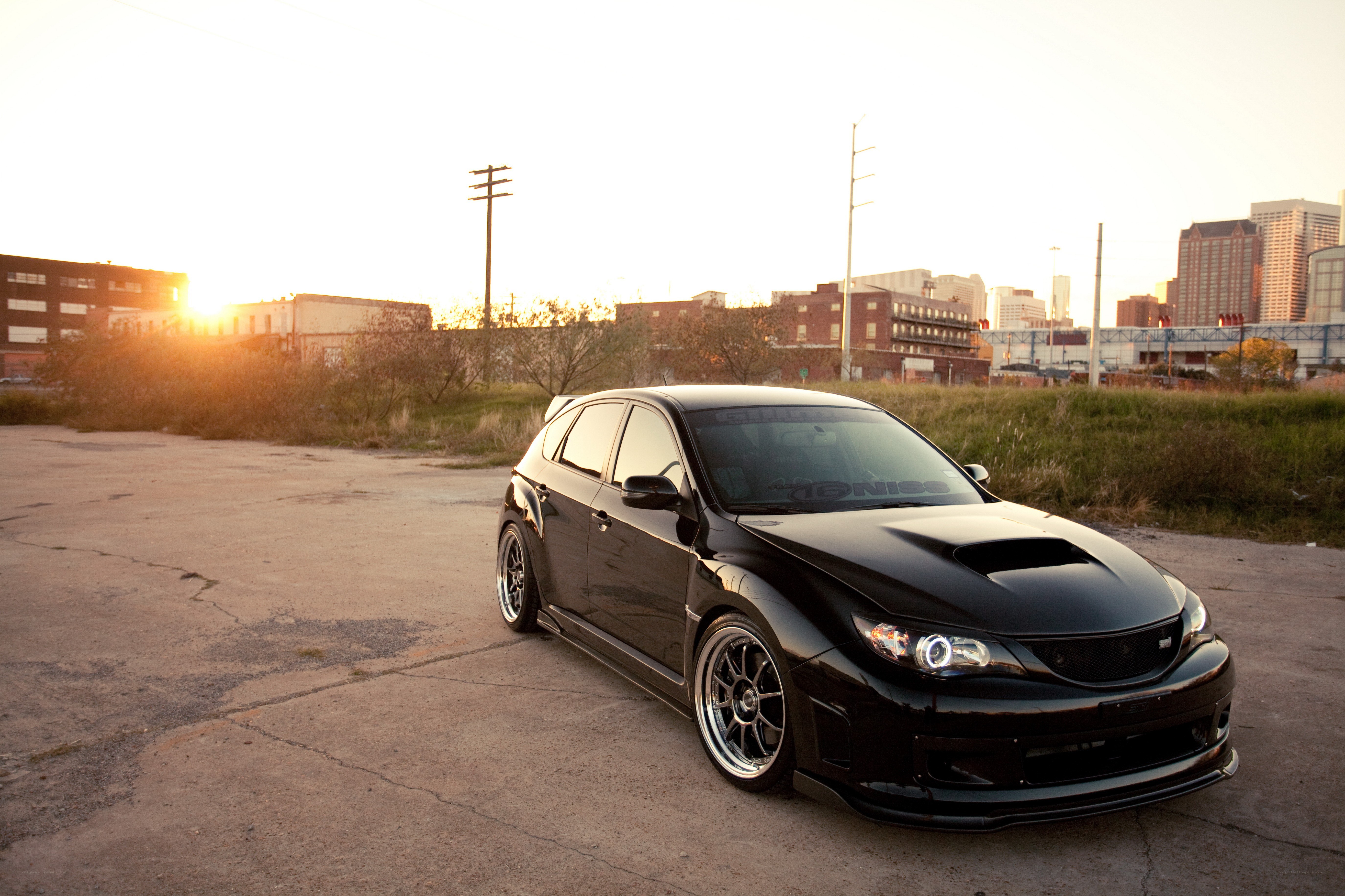 black subaru in urban setting