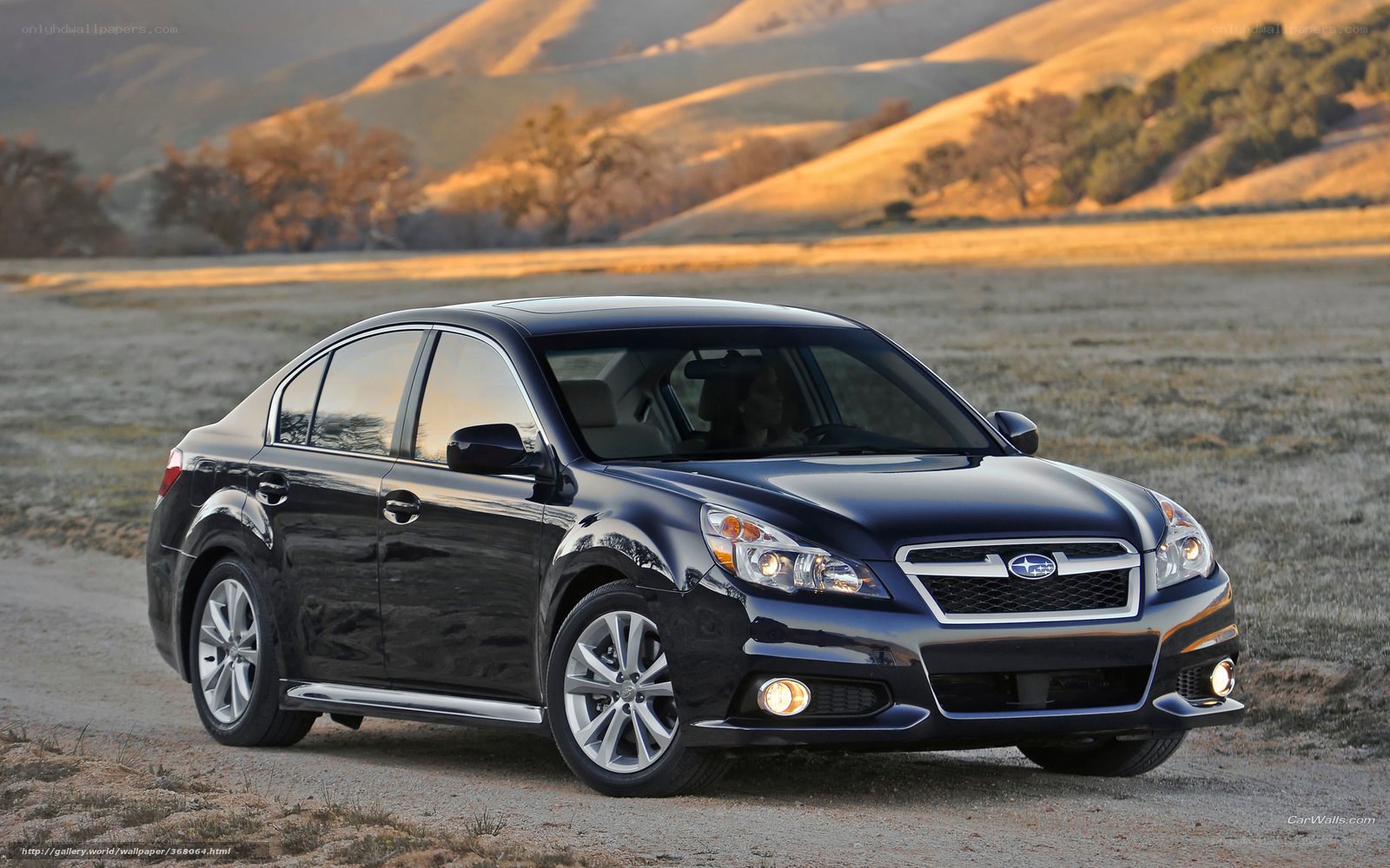 Black Subaru Legacy on a dirt road