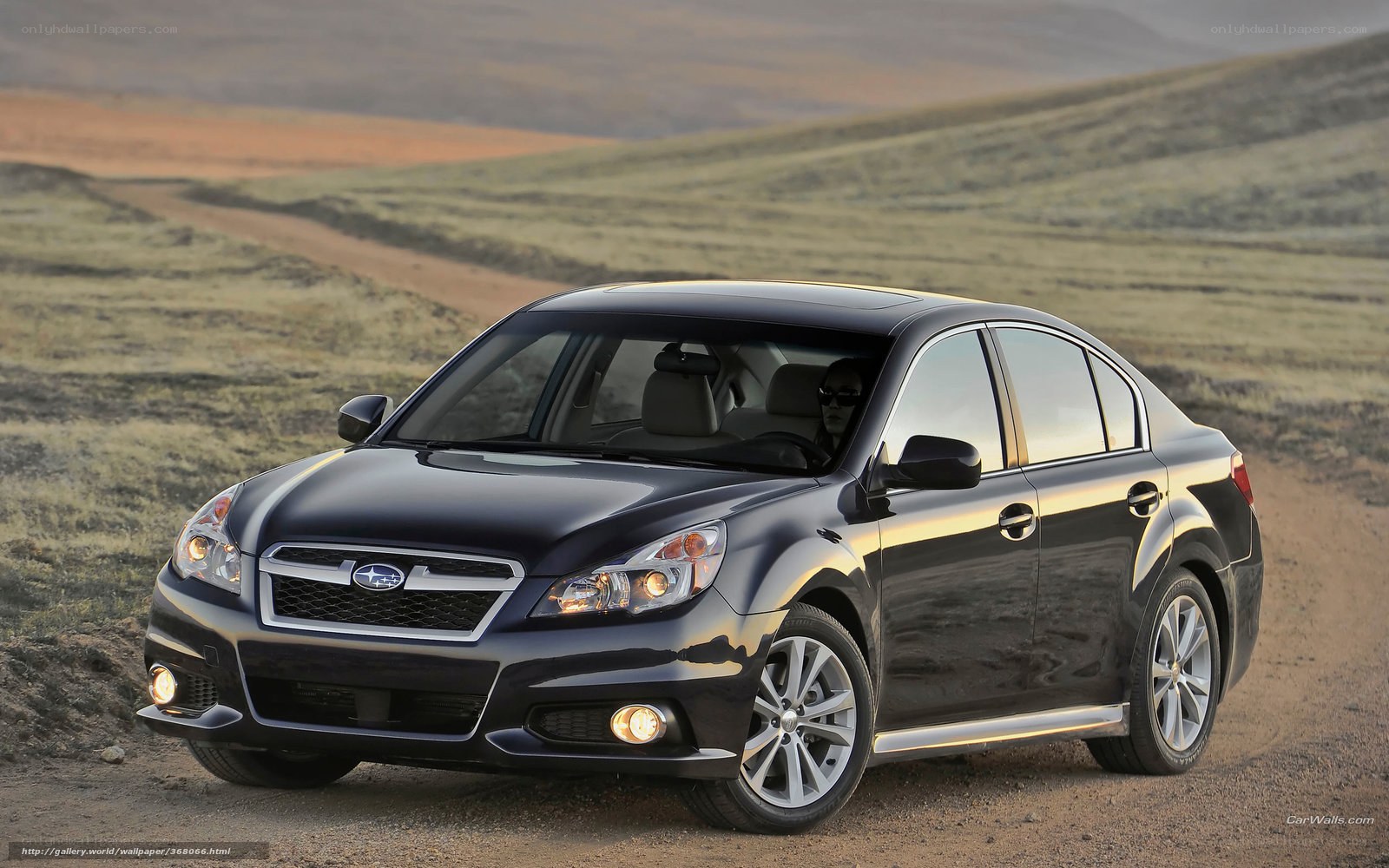 Black Subaru Legacy on dirt road