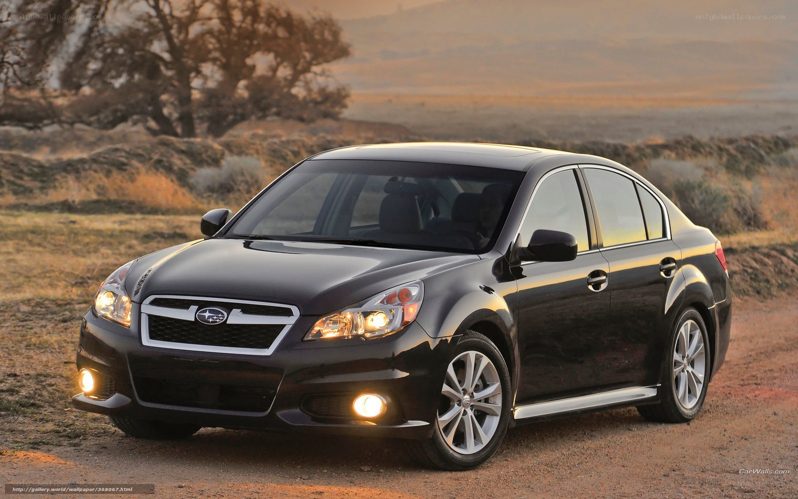Black Subaru Legacy on dirt road