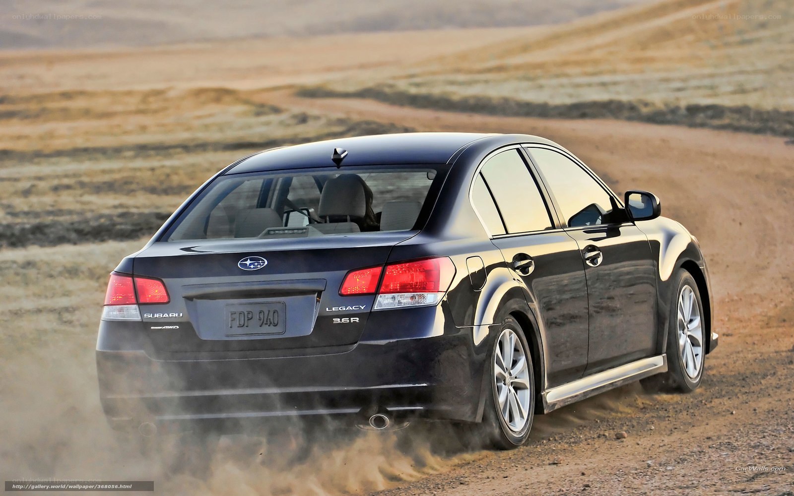 black subaru legacy on dirt road
