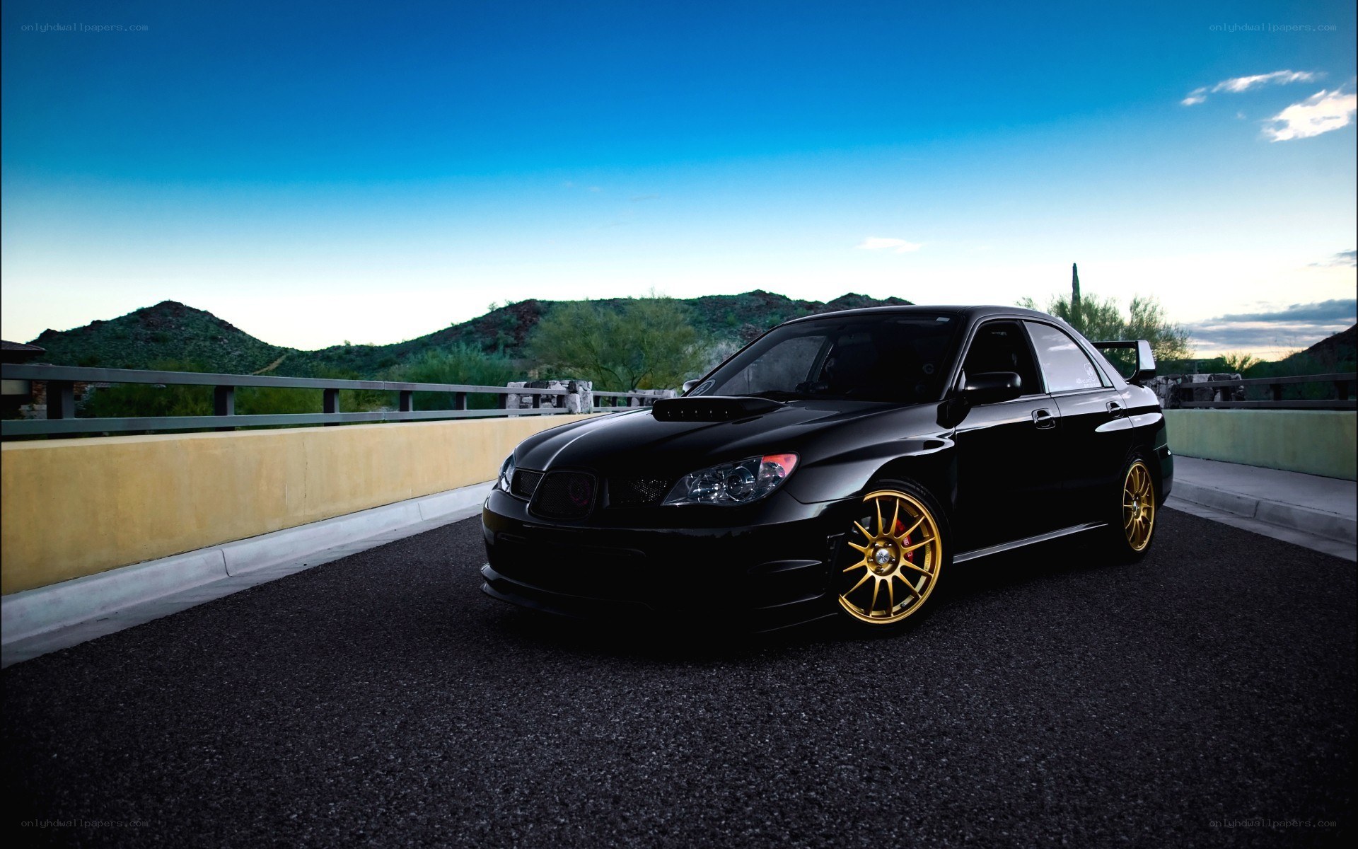 Black Subaru on a desert road
