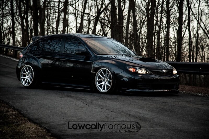 Black Subaru on a forest road
