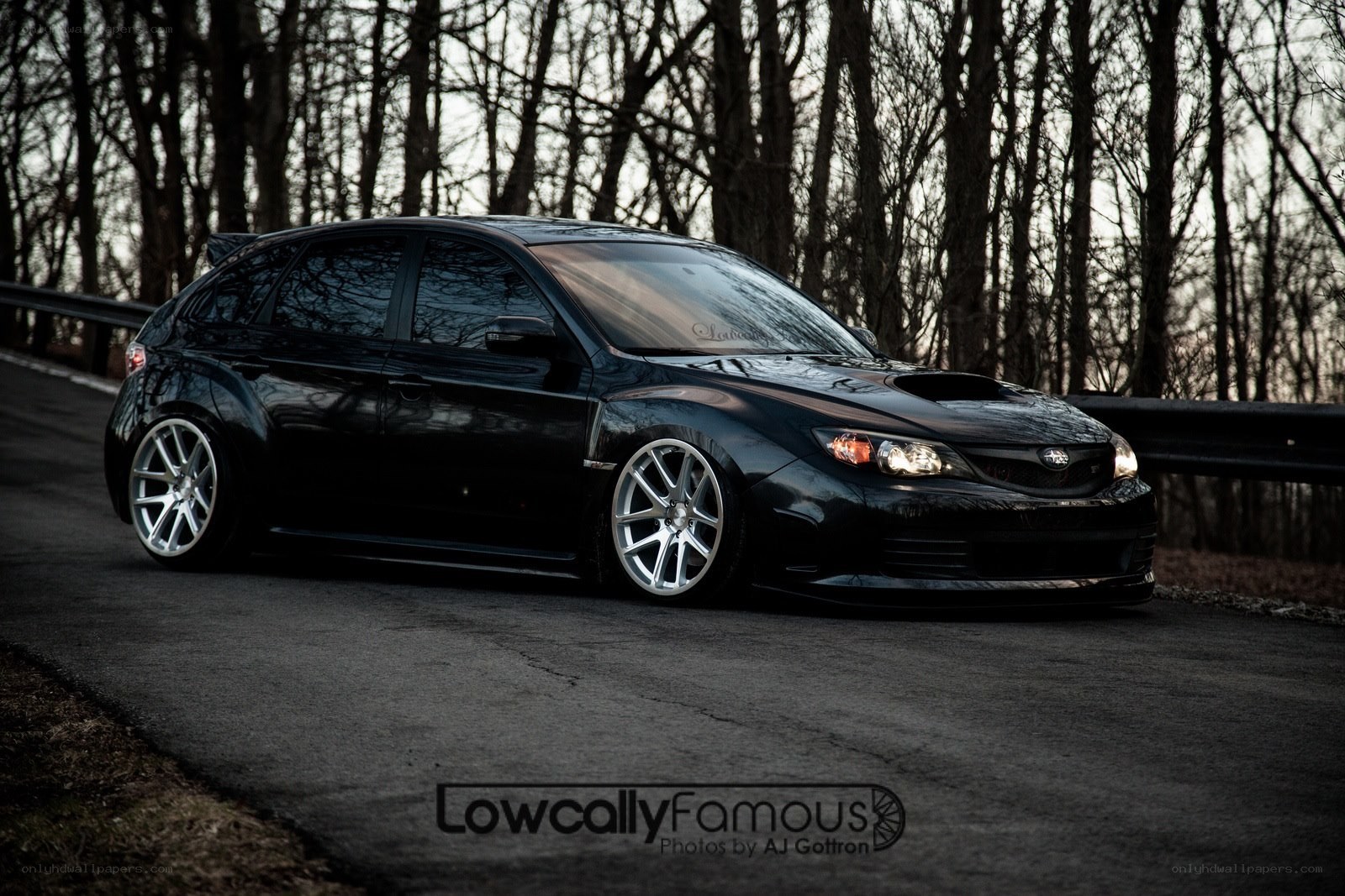 Black Subaru on a forest road
