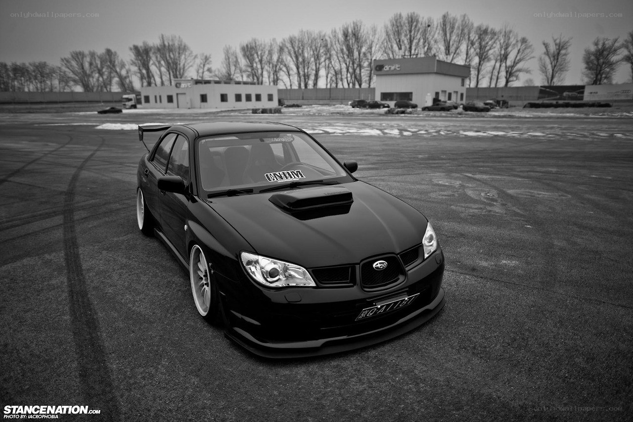 Black Subaru on a racetrack