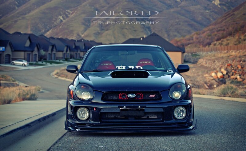 black subaru on a suburban street