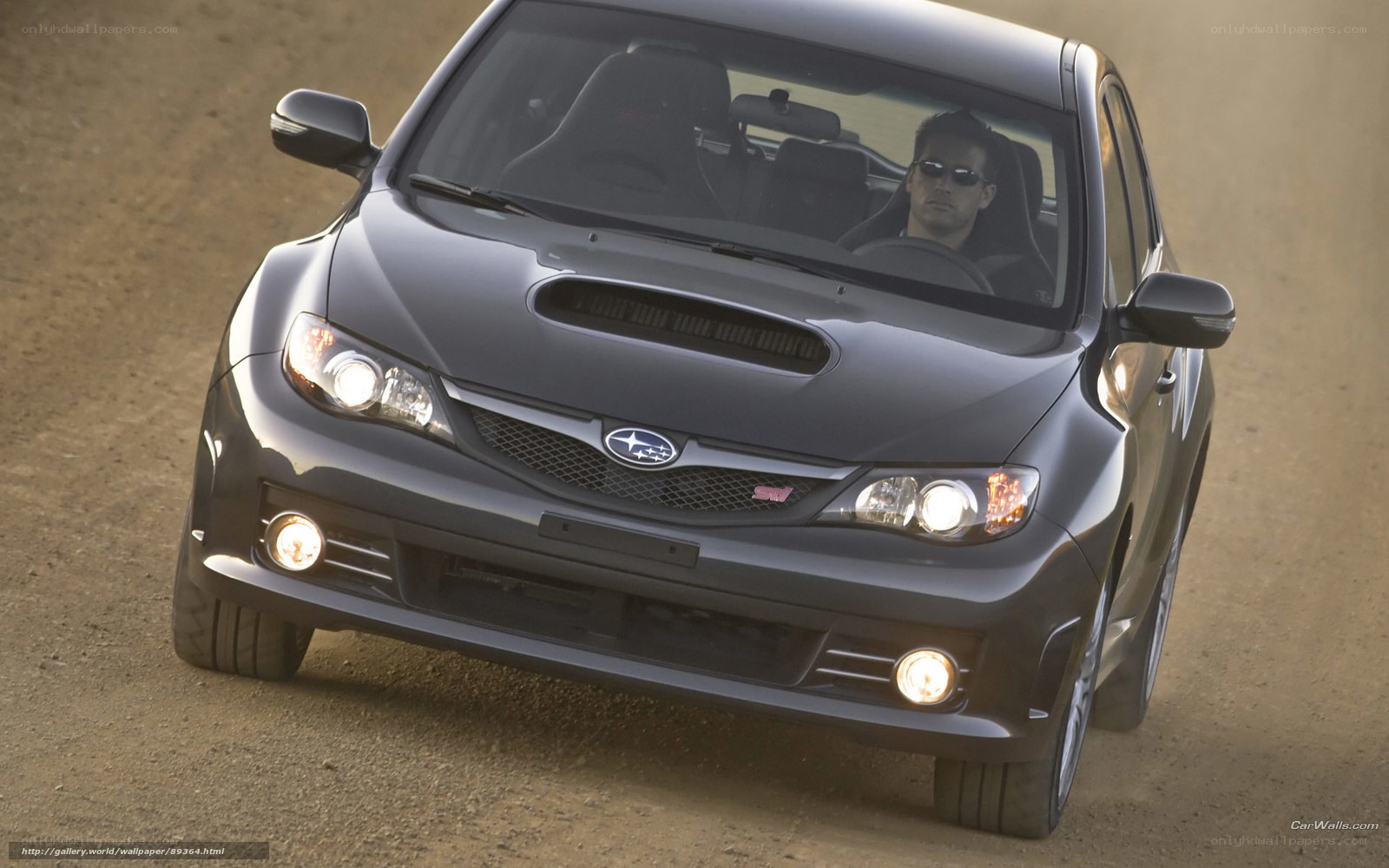 black subaru on dirt road
