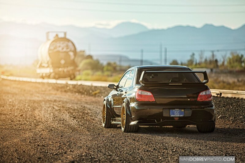 Black Subaru on gravel road