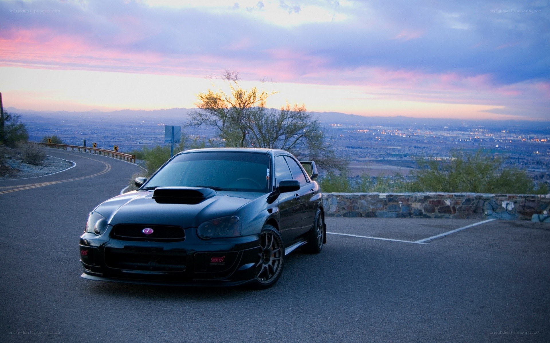 black subaru on mountain road