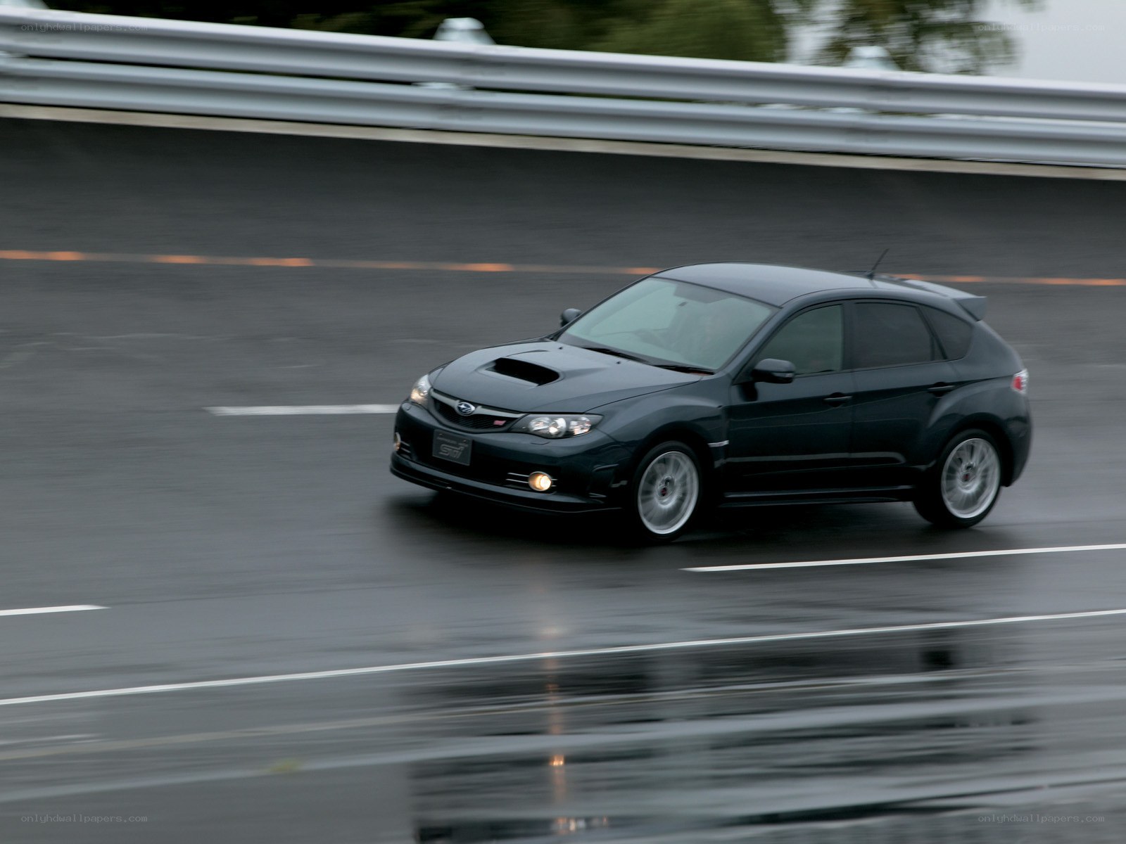 black subaru on wet road