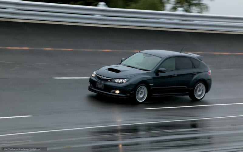 black subaru on wet road