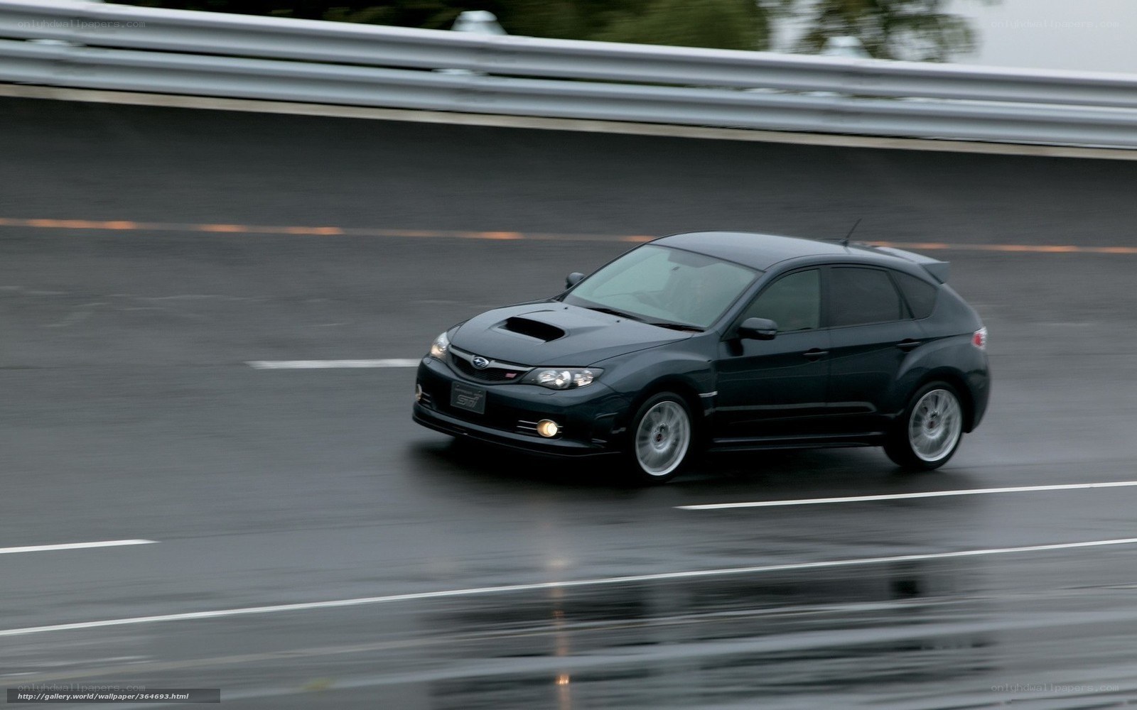 black subaru on wet road