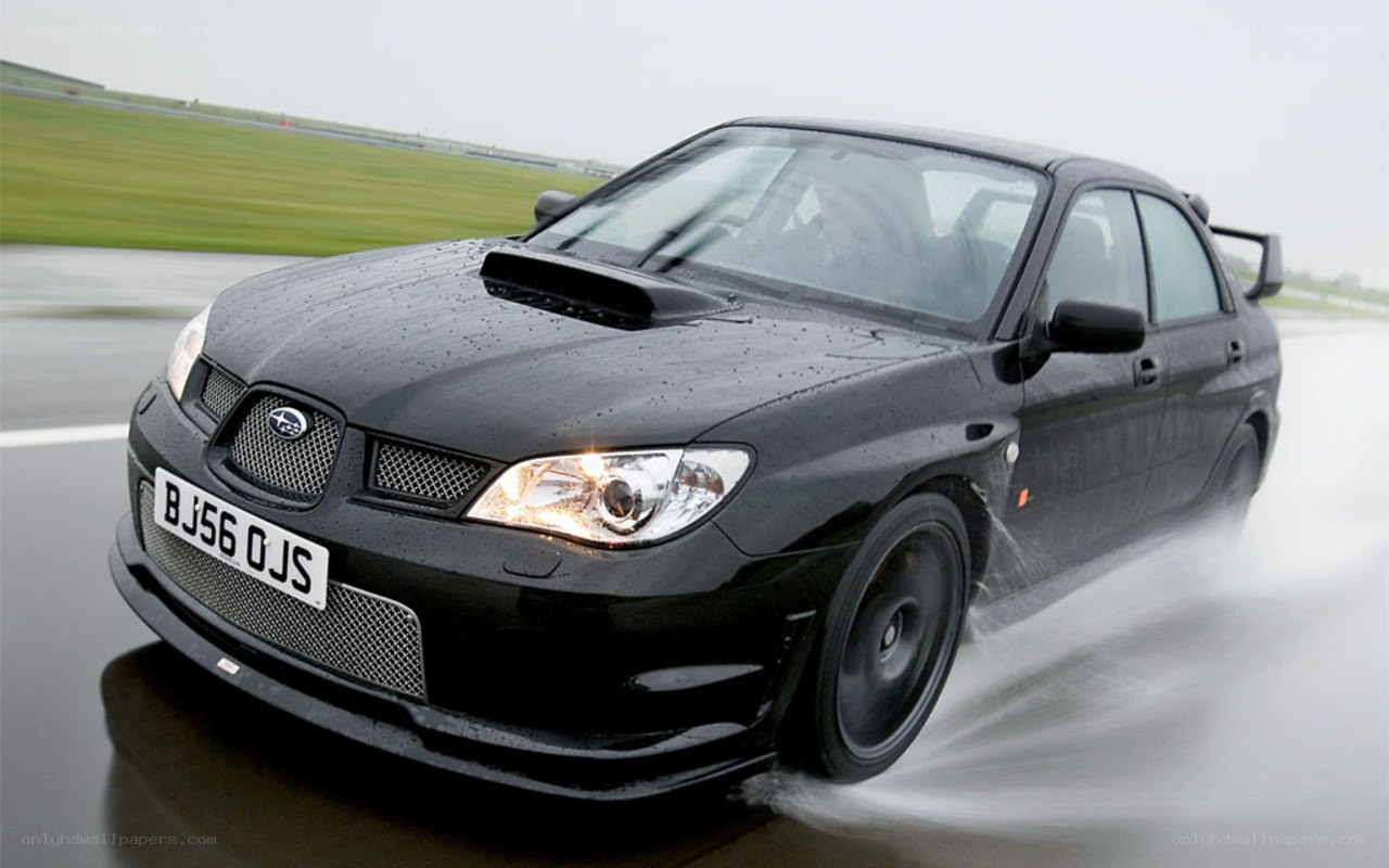 black subaru on wet track