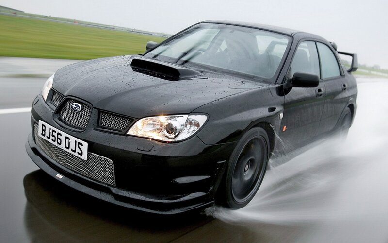 black subaru on wet track