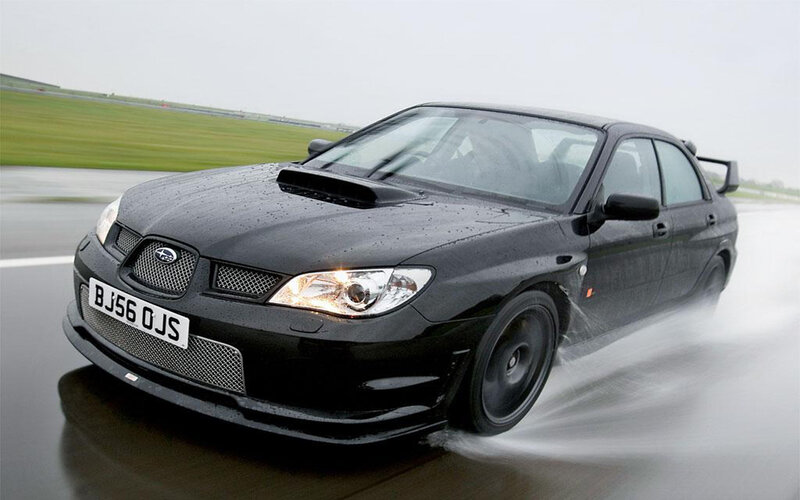 black subaru on wet track