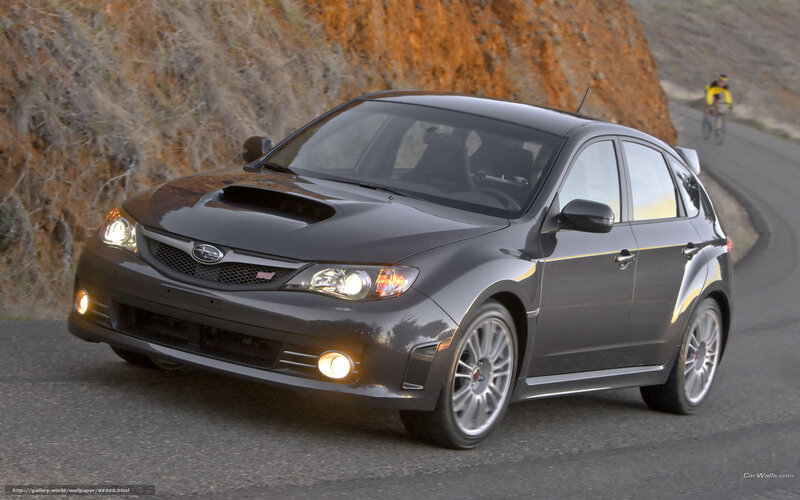 black subaru on winding road