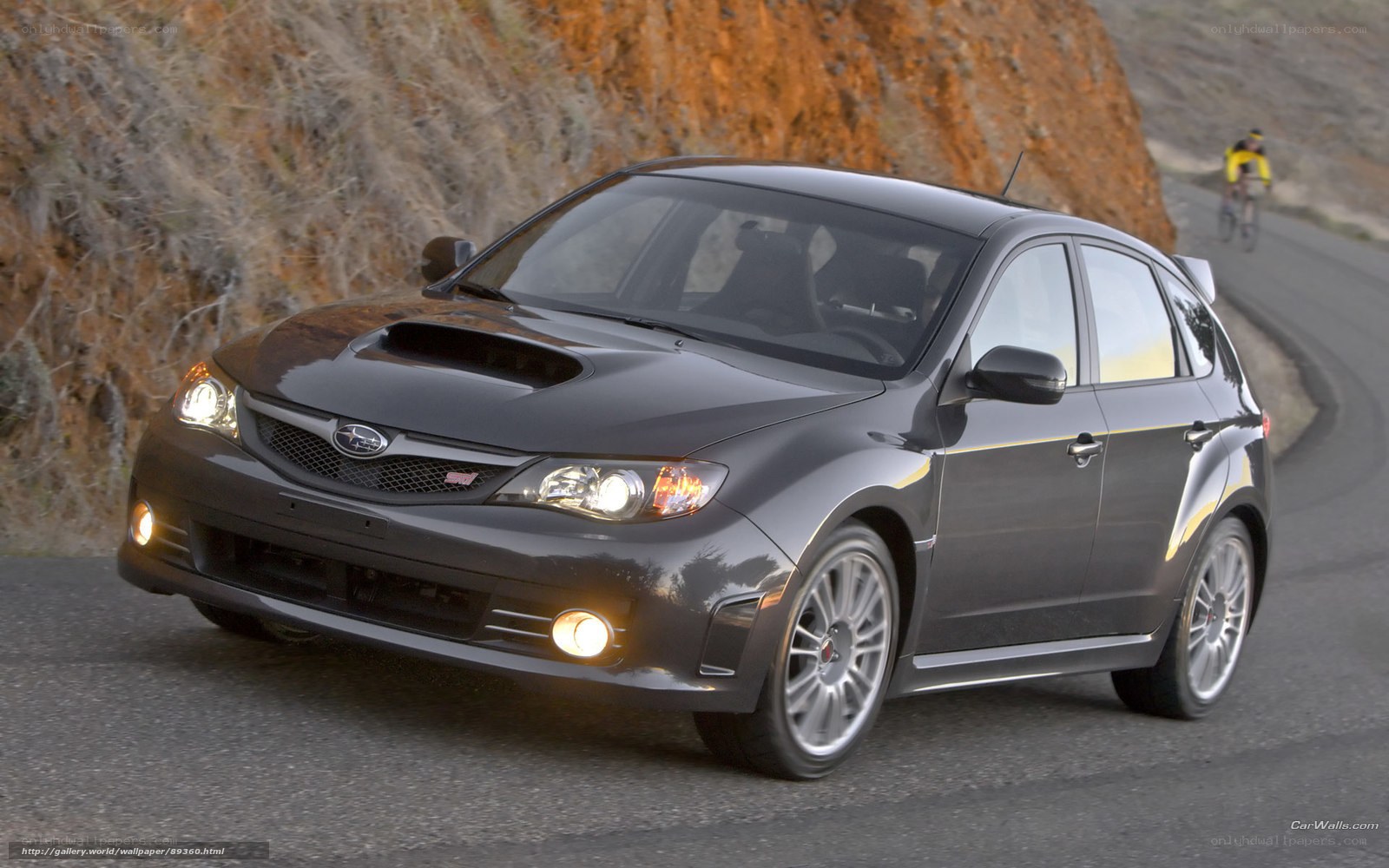 black subaru on winding road