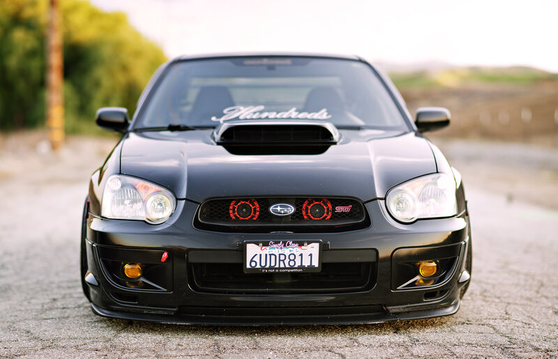 Black Subaru STI front view
