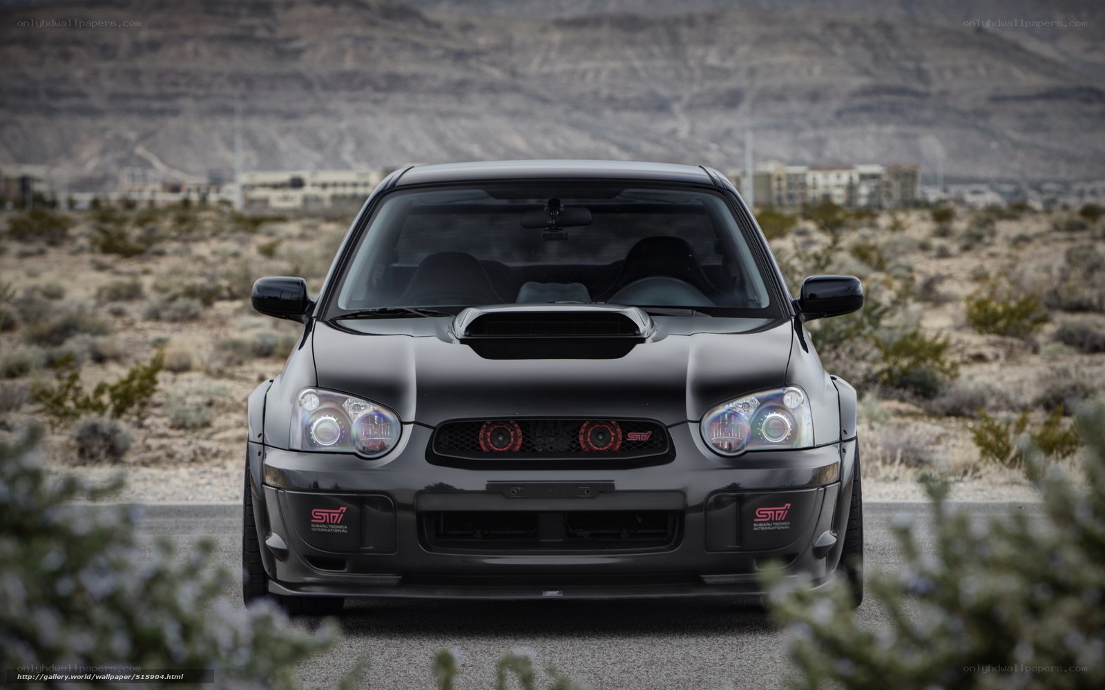 black subaru sti in desert
