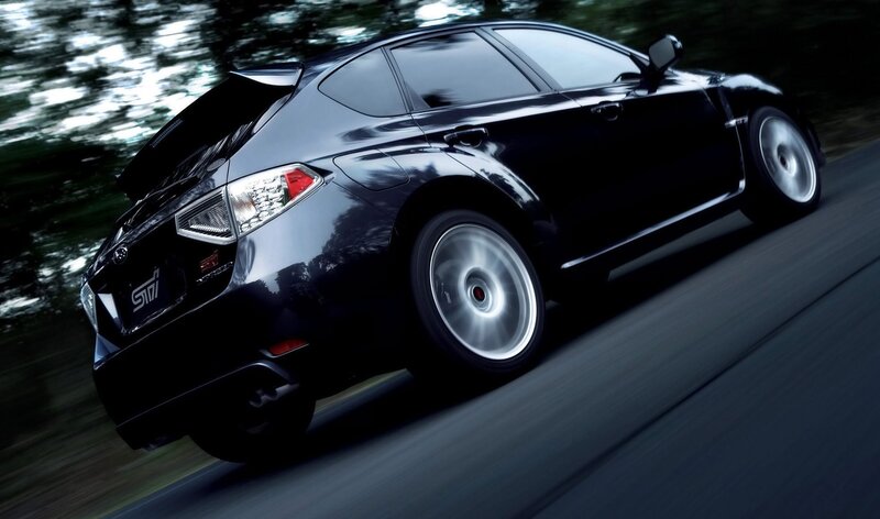 black subaru sti in motion