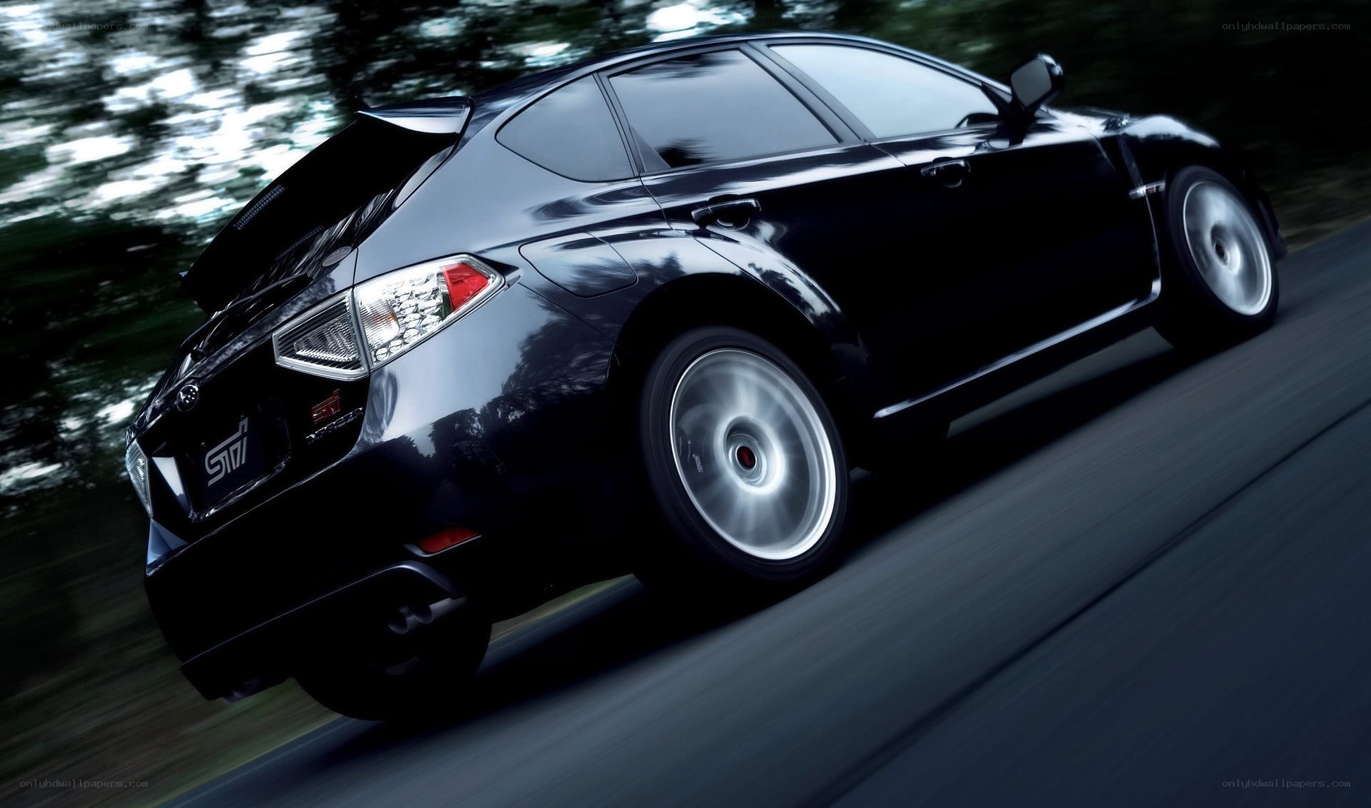 black subaru sti in motion