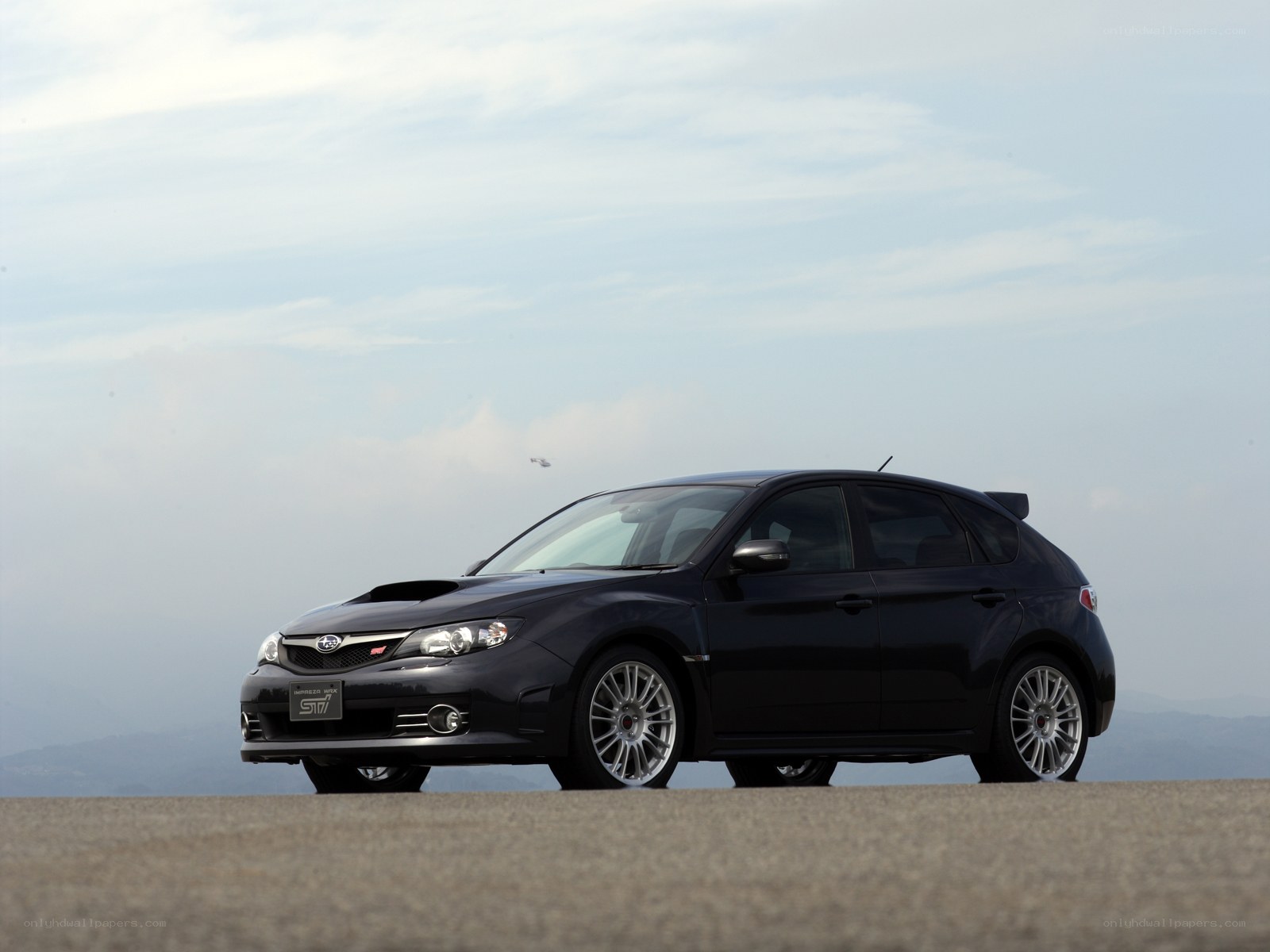 Black Subaru STI on a road