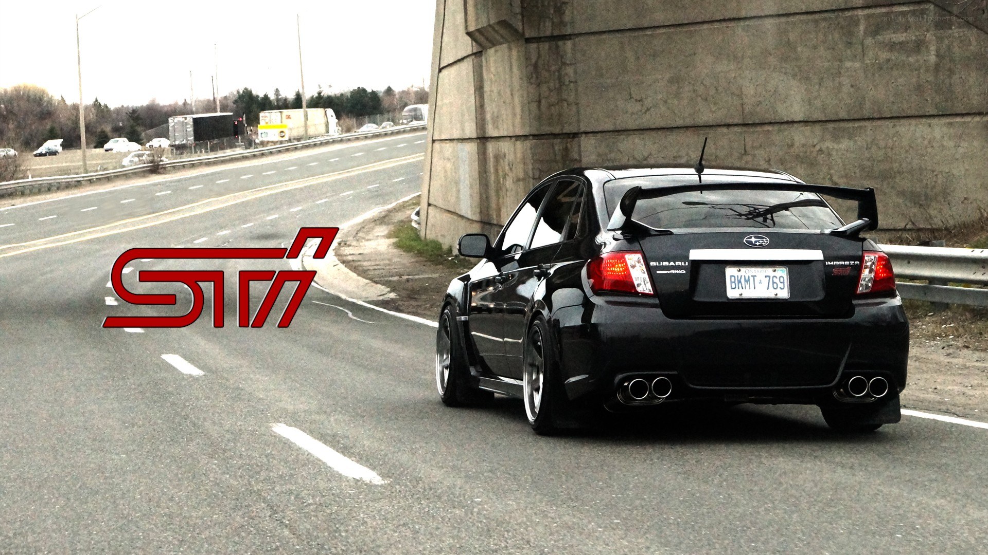 black subaru sti on highway