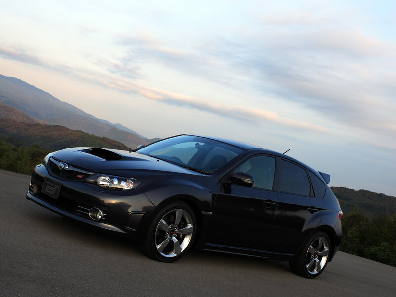 Black Subaru STI on mountain road