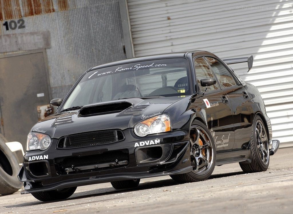 black subaru with racing modifications