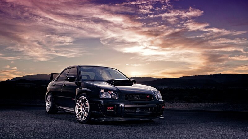 Black Subaru WRX at sunset